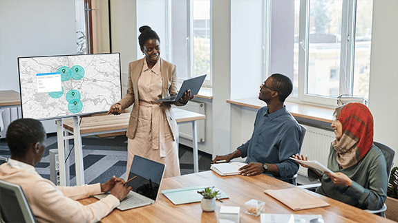 Salesperson presenting a coverage area map in a client meeting