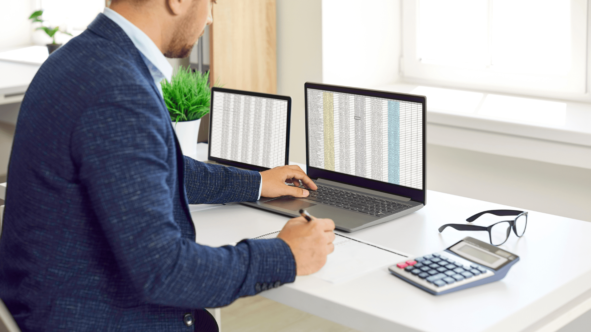 Sales person sitting at a laptop with cluttered spreadsheets open